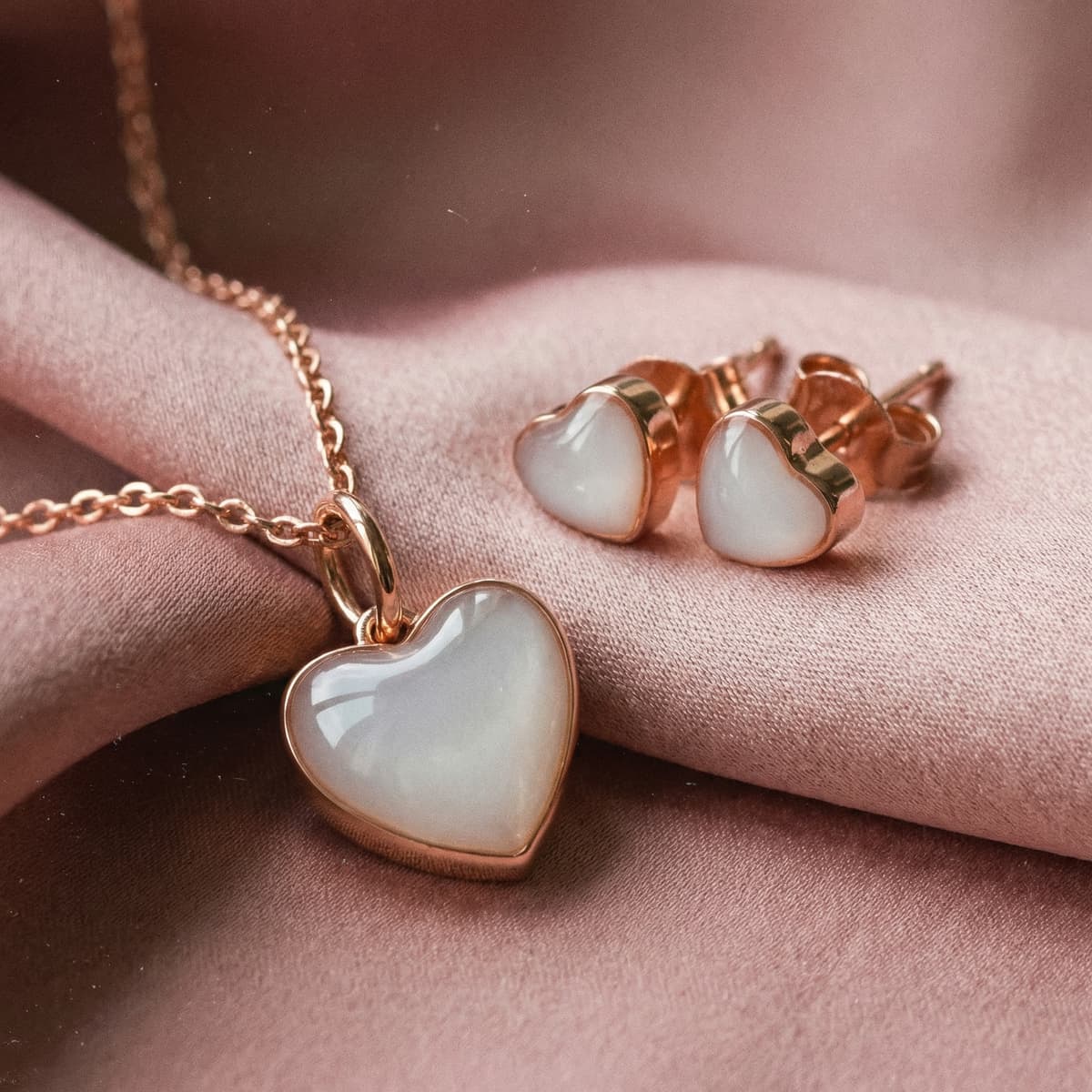Rose gold heart pendant necklace with matching heart stud earrings featuring a milky white stone, sentimental keepsake jewelry set perfect as a 1 year breastfeeding gift
