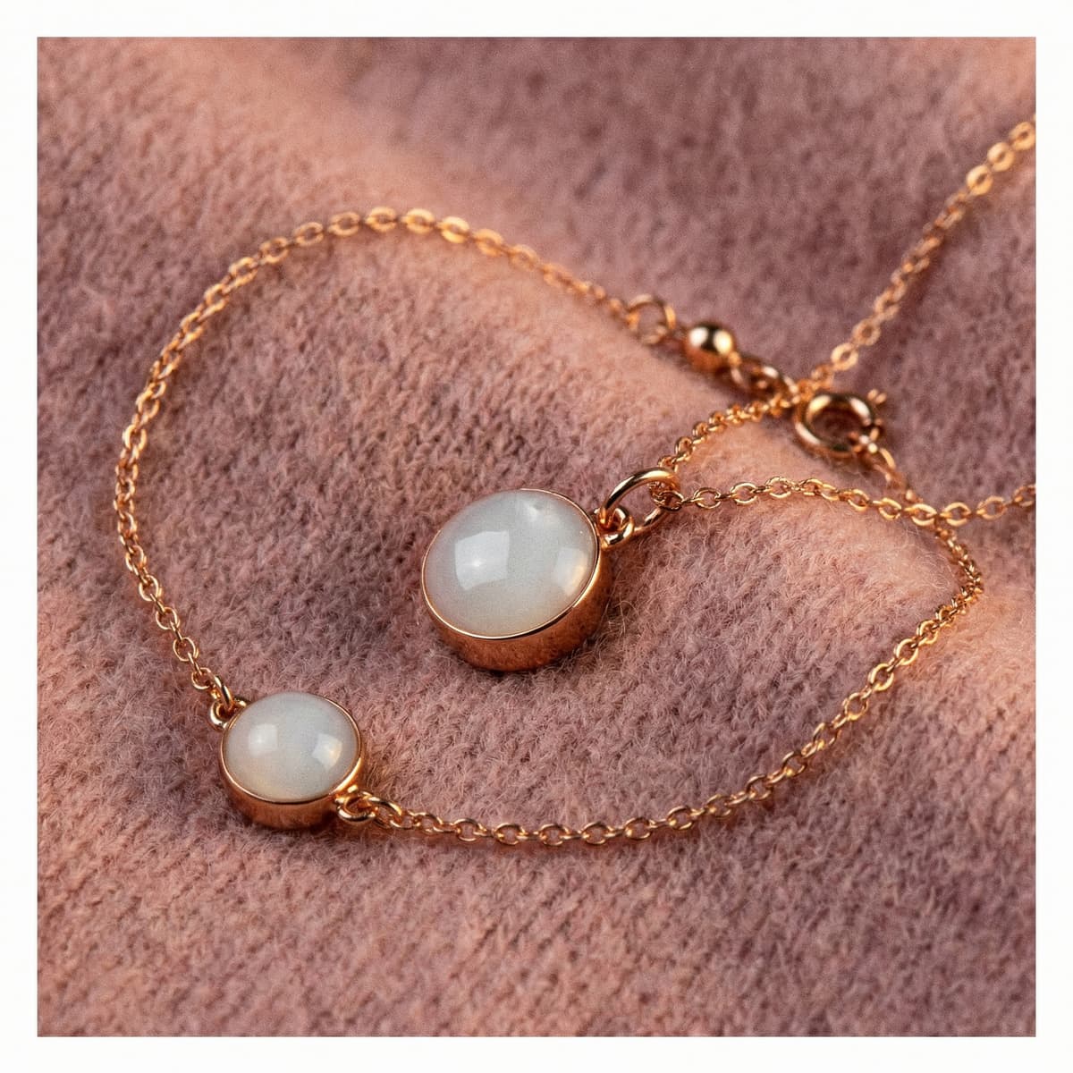 Delicate rose-gold bracelet with two milky white resin stones on a soft pink background, a sentimental keepsake jewelry idea for the best push presents for new moms