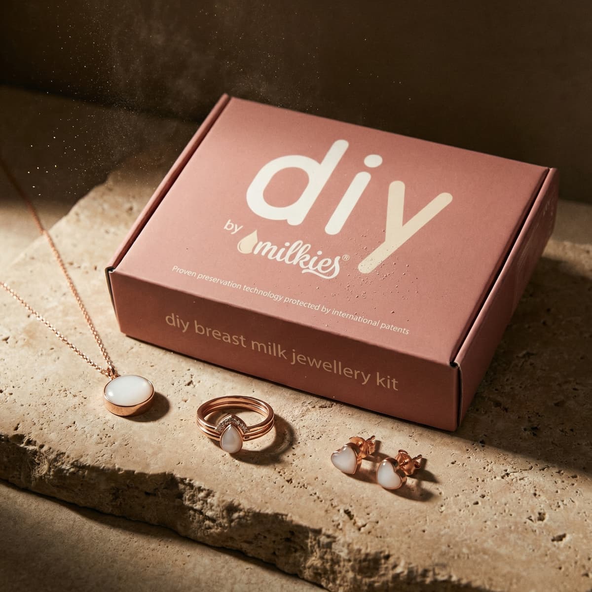 DIY by Milkies box displaying necklace, ring and stud earrings from an at-home diy breastmilk jewellery kit for creating preserved breastmilk resin keepsake pieces